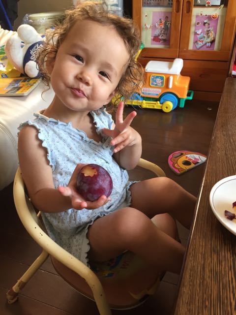Yurika is eating a plum. 